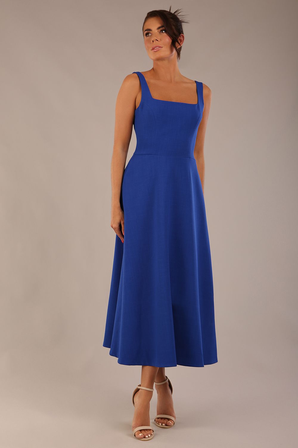 model wearing a diva catwalk Tamsin Square Neckline Swing Dress sleeveless style with a midaxi  length and side pockets in cobalt blue colour (Cobalt blue)
