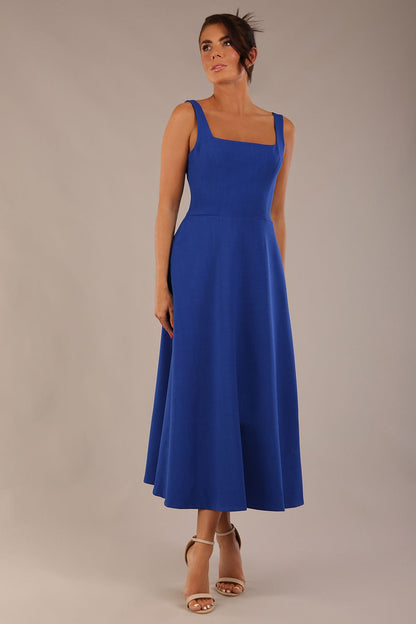 model wearing a diva catwalk Tamsin Square Neckline Swing Dress sleeveless style with a midaxi  length and side pockets in cobalt blue colour (Cobalt blue)