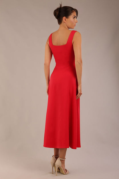 woman wearing a diva catwalk Tamsin Square Neckline Swing Dress sleeveless style with a midaxi  length and side pockets in Scarlet Red colour in Budapest (Scarlet Red)