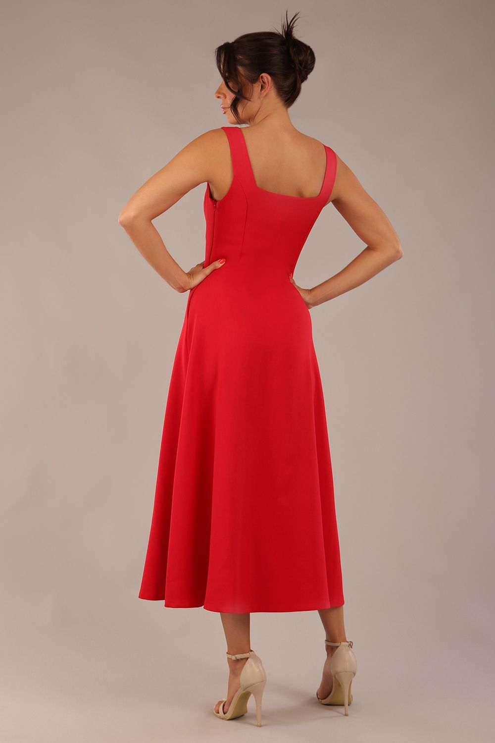 woman wearing a diva catwalk Tamsin Square Neckline Swing Dress sleeveless style with a midaxi  length and side pockets in Scarlet Red colour in Budapest (Scarlet Red)