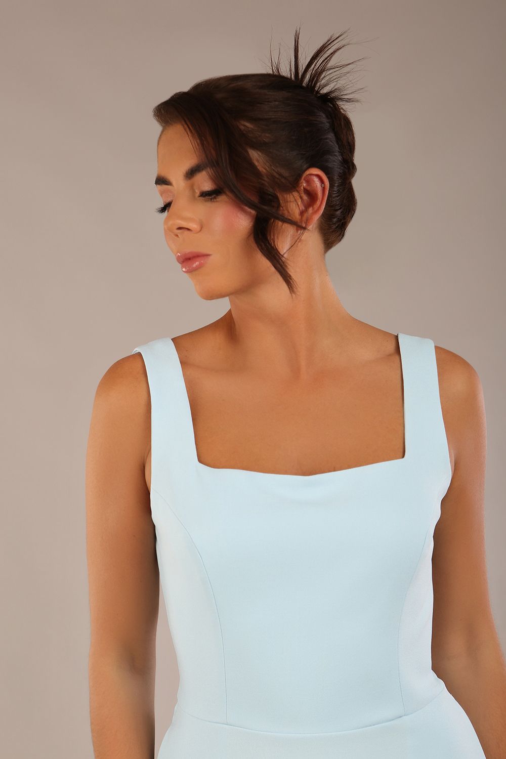 brunette model is wearing a diva catwalk Tamsin Square Neckline Swing Dress sleeveless style with a midaxi  length and side pockets in Sky blue colour front