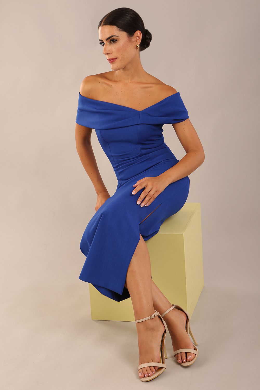 brunette model is wearing a diva catwalk Mariposa Longer Length Dress off the shoulder bardot neckline and midaxi length in cobalt blue colour front image