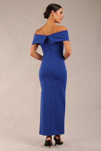 brunette model is wearing a diva catwalk Mariposa Longer Length Dress off the shoulder bardot neckline and midaxi length in cobalt blue colour front image