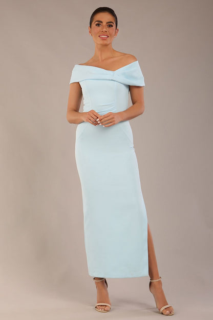 brunette model is wearing a diva catwalk Mariposa Longer Length Dress off the shoulder bardot neckline and midaxi length in sky blue colour front image