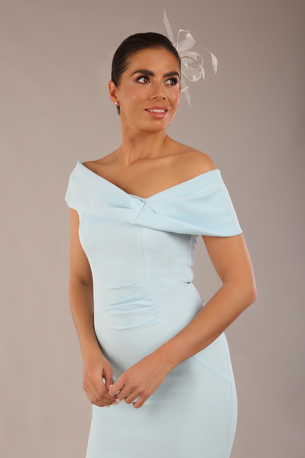 brunette model is wearing a diva catwalk Mariposa Longer Length Dress off the shoulder bardot neckline and midaxi length in sky blue colour front image
