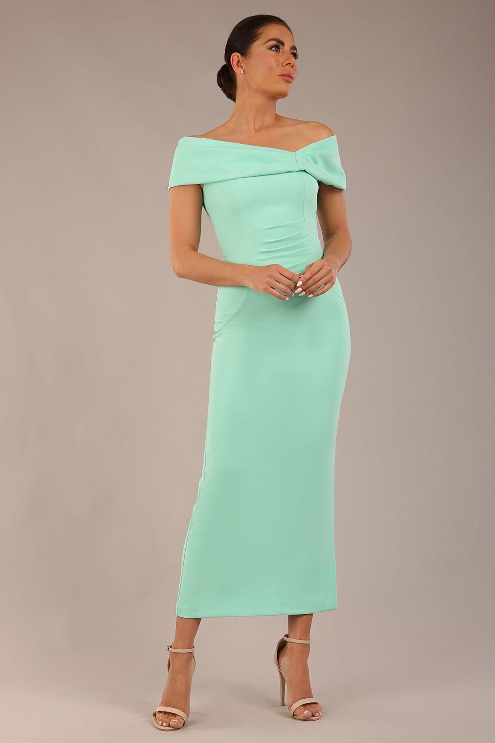 brunette model is wearing a diva catwalk Mariposa Longer Length Dress off the shoulder bardot neckline and midaxi length in mint green colour back image