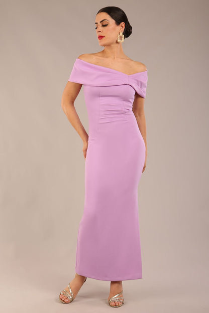 brunette model is wearing a diva catwalk Mariposa Longer Length Dress off the shoulder bardot neckline and midaxi length in sheer lilac colour front image