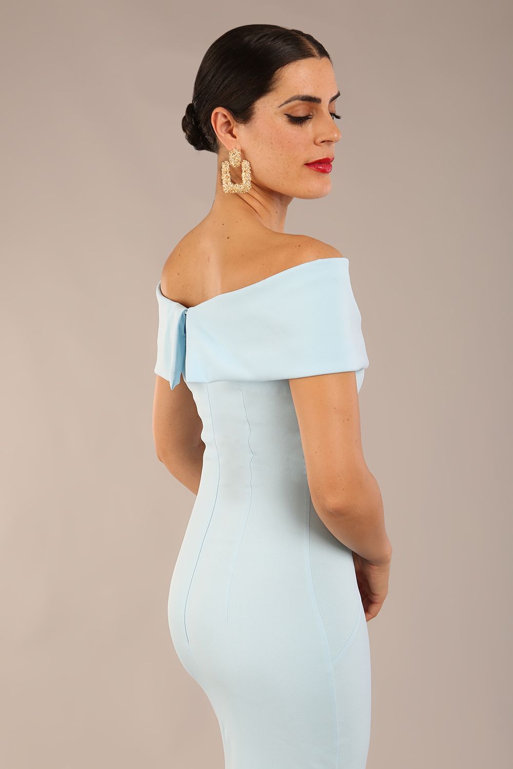 brunette model is wearing a diva catwalk Mariposa Longer Length Dress off the shoulder bardot neckline and midaxi length in sky blue colour front image