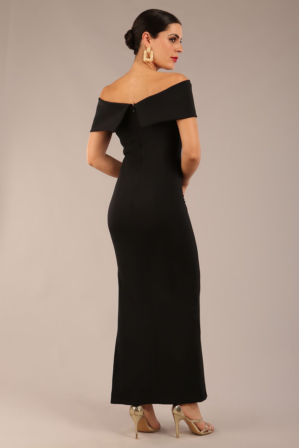 brunette model is wearing a diva catwalk Mariposa Longer Length Dress off the shoulder bardot neckline and midaxi length in black colour back image