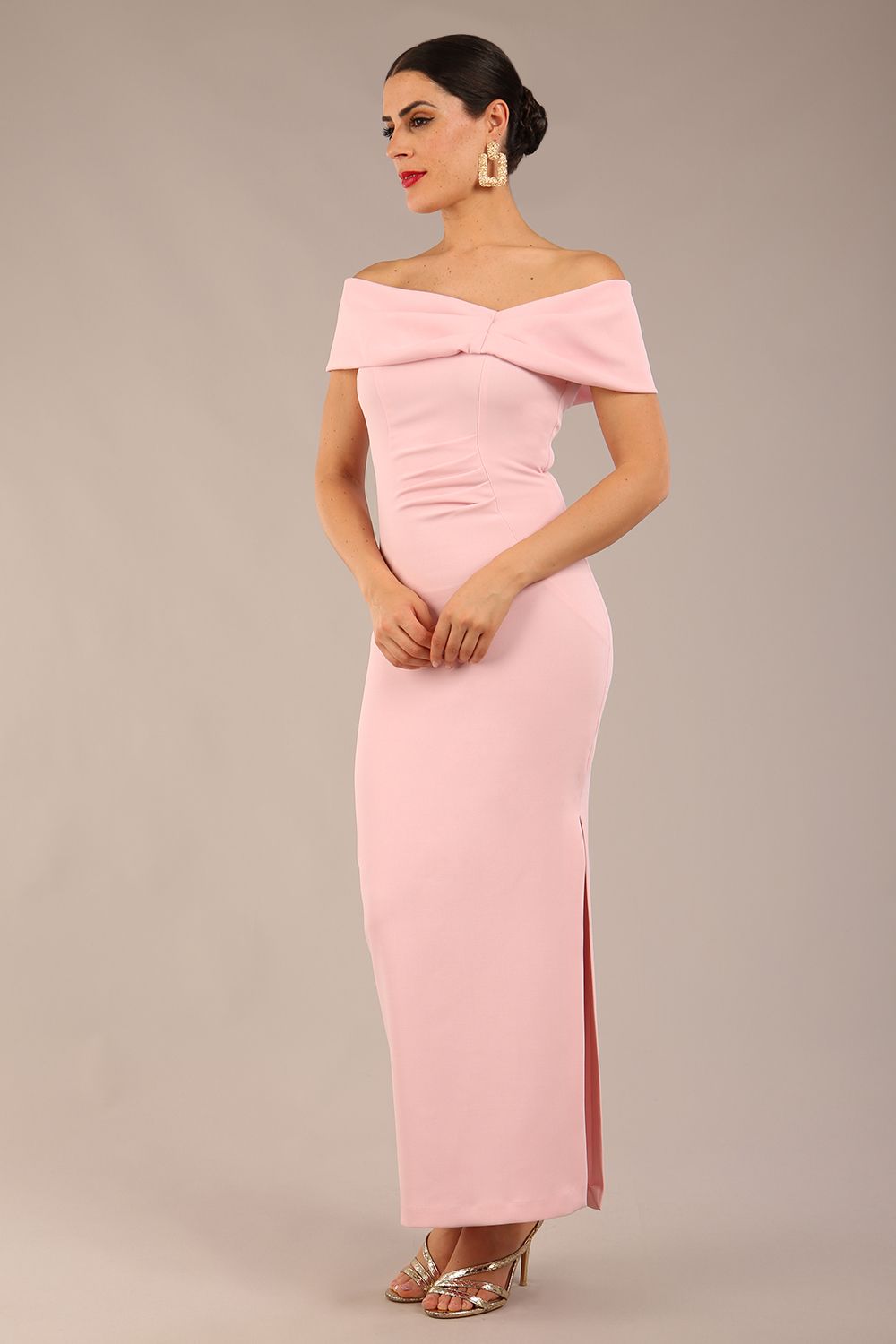 brunette model is wearing a diva catwalk Mariposa Longer Length Dress off the shoulder bardot neckline and midaxi length in crystal pink colour front image close up