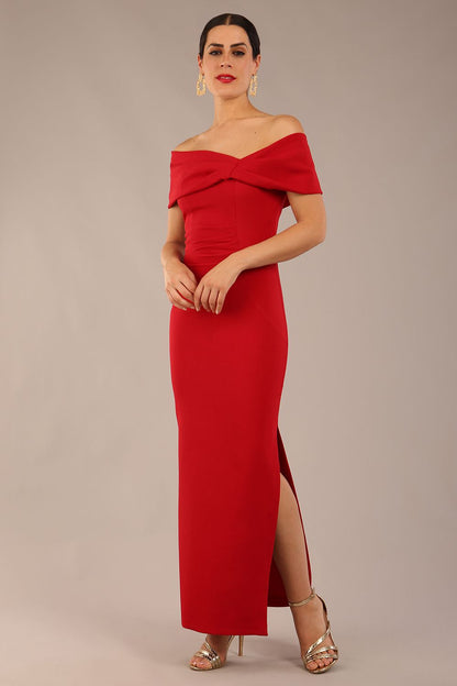 brunette model is wearing a diva catwalk Mariposa Longer Length Dress off the shoulder bardot neckline and midaxi length in dark red colour front image
