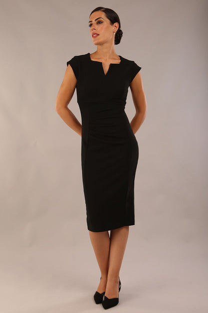 model wearing a diva catwalk Thea Cap Sleeved Pencil Dress with square neckline with a v-slit and knee length in ribbed super stretch fabric in black front