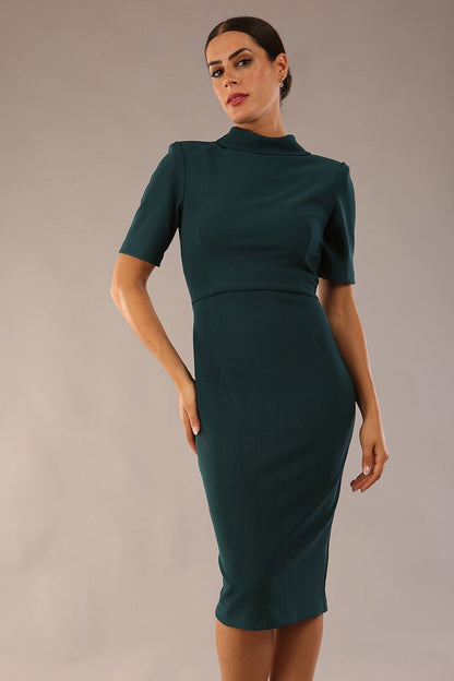 model is wearing a diva catwalk Highmoor Short Sleeved Pencil Dress high neckline and shoulders pads in green colour