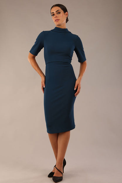 model is wearing a diva catwalk Highmoor Short Sleeved Pencil Dress high neckline and shoulders pads in teal colour