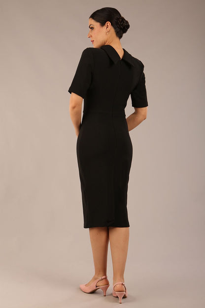 model is wearing a diva catwalk Highmoor Short Sleeved Pencil Dress high neckline and shoulders pads in black colour