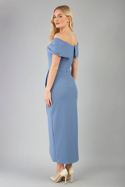model wearing diva catwalk vegas calf length stone blue midaxi dress with wide bardot neckline and open shoulders with a large opening at the front of the skirt with pleating coming down long skirt front (Stone Blue)