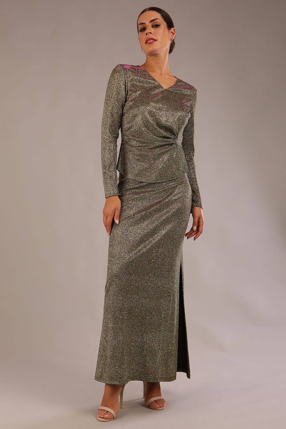model wearing a diva catwalk Zeta Glitter Two-Piece Set with long sleeves v neckline and gathered detail on the top and side slit detail on the full length skirt in glitter stretch fabric in sherwood glitter colour - 2 pieces