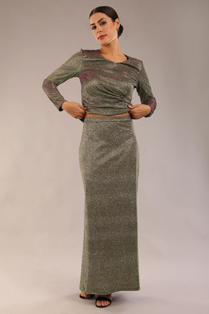 model wearing a diva catwalk Zeta Glitter Two-Piece Set with long sleeves v neckline and gathered detail on the top and side slit detail on the full length skirt in glitter stretch fabric in sherwood glitter colour - 2 pieces