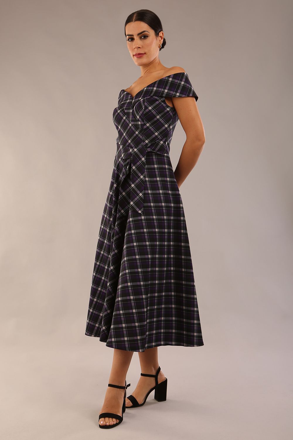 model is wearing a diva catwalk Montclair Tartan Off-Shoulder Midi Dress bardot neckline with tie detail at the waist area a-line style in royal purple tartan colour (Royal Purple Tartan)