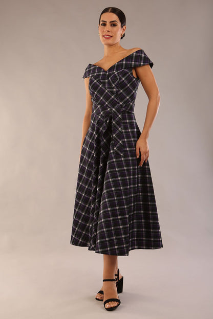 model is wearing a diva catwalk Montclair Tartan Off-Shoulder Midi Dress bardot neckline with tie detail at the waist area a-line style in royal purple tartan colour (Royal Purple Tartan)
