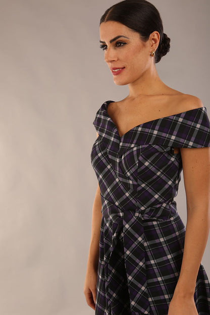 model is wearing a diva catwalk Montclair Tartan Off-Shoulder Midi Dress bardot neckline with tie detail at the waist area a-line style in royal purple tartan colour (Royal Purple Tartan)