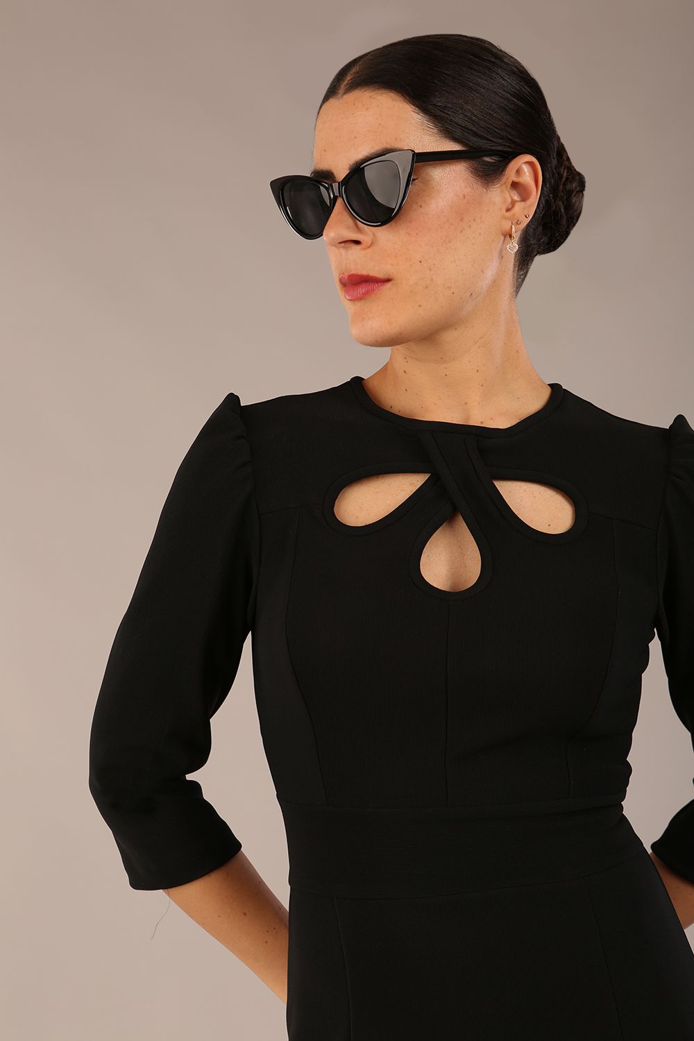 model is wearing a diva catwalk Quintessa Three Petal Keyhole Pencil Dress with 3/4 sleeves round neckline a below the knee length in black colour