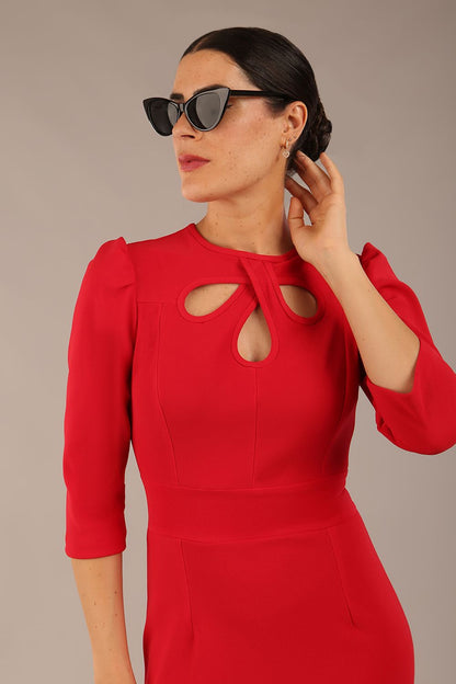 model is wearing a diva catwalk Quintessa Three Petal Keyhole Pencil Dress with 3/4 sleeves round neckline a below the knee length in red colour