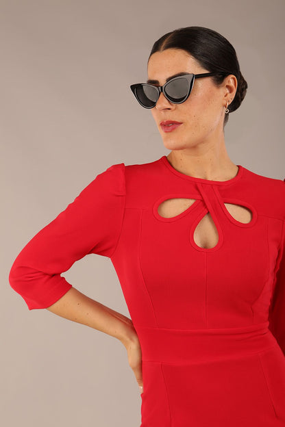 model is wearing a diva catwalk Quintessa Three Petal Keyhole Pencil Dress with 3/4 sleeves round neckline a below the knee length in red colour