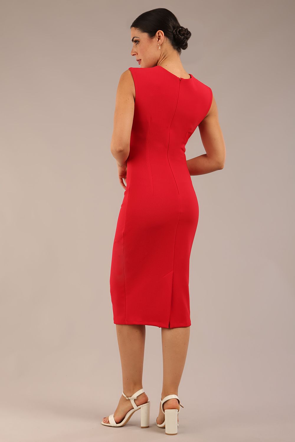 model is wearing a diva catwalk sleeveless dress with round neckline with pleating details and knee length in true red colour 