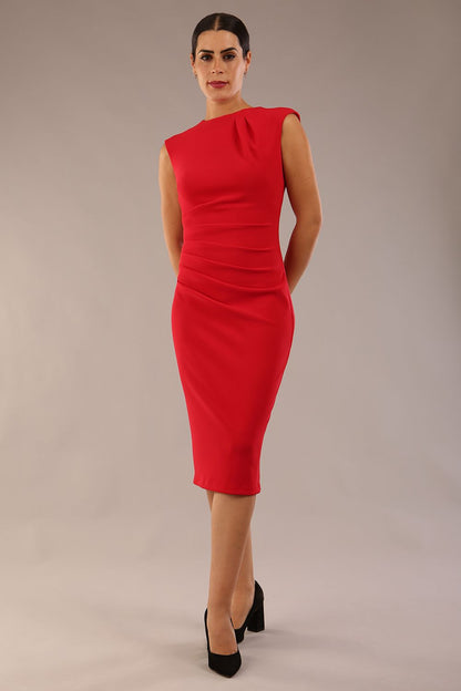 model is wearing a diva catwalk sleeveless dress with round neckline with pleating details and knee length in true red colour 