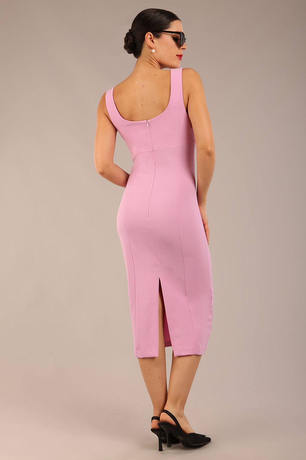 brunette model is wearing a diva catwalk Perthshire Sleeveless Bodycon Pencil Dress square neckline in dawn pink colour front image 