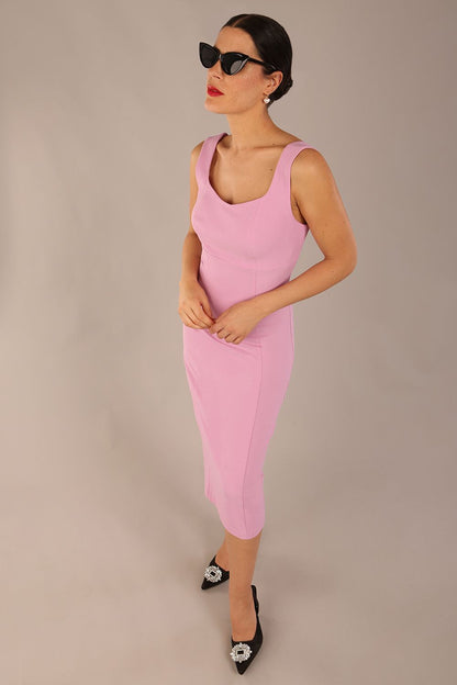 brunette model is wearing a diva catwalk Perthshire Sleeveless Bodycon Pencil Dress square neckline in dawn pink colour front image 