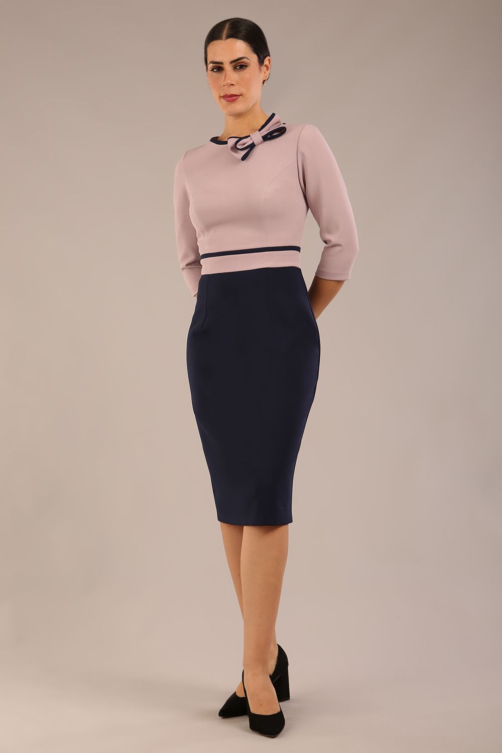 brunette model is wearing a diva catwalk Cherie Sleeved Contrast Bow Neck Pencil Dress round neckline  in Navy Blue-Thunderbird front image (Navy Blue-Thunderbird)