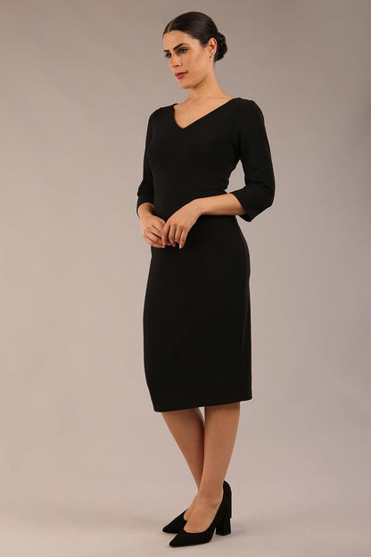 brunette model is wearing a  diva catwalk Tara V-neckline Sleeved Pencil Dress knee length in black colour front image with sunglasses