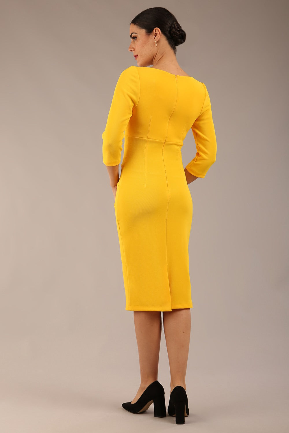 brunette model is wearing a  diva catwalk Tara V-neckline Sleeved Pencil Dress knee length in sunshine yellow colour front image with sunglasses