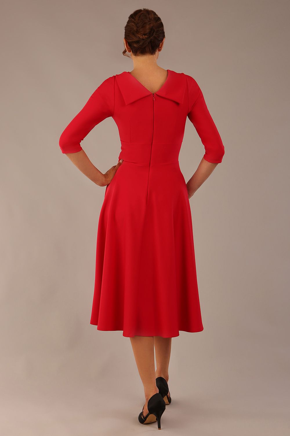 brunette model is wearing a diva catwalk Fabienne sleeved A-line Dress with pockets v neckline knee length wide waistband fold over v neckline in electric red colour front image (Electric Red)