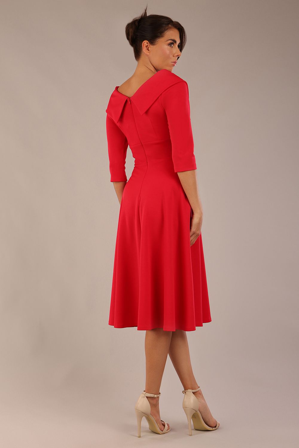 brunette model is wearing a diva catwalk Fabienne sleeved A-line Dress with pockets v neckline knee length wide waistband fold over v neckline in electric red colour front image (Electric Red)