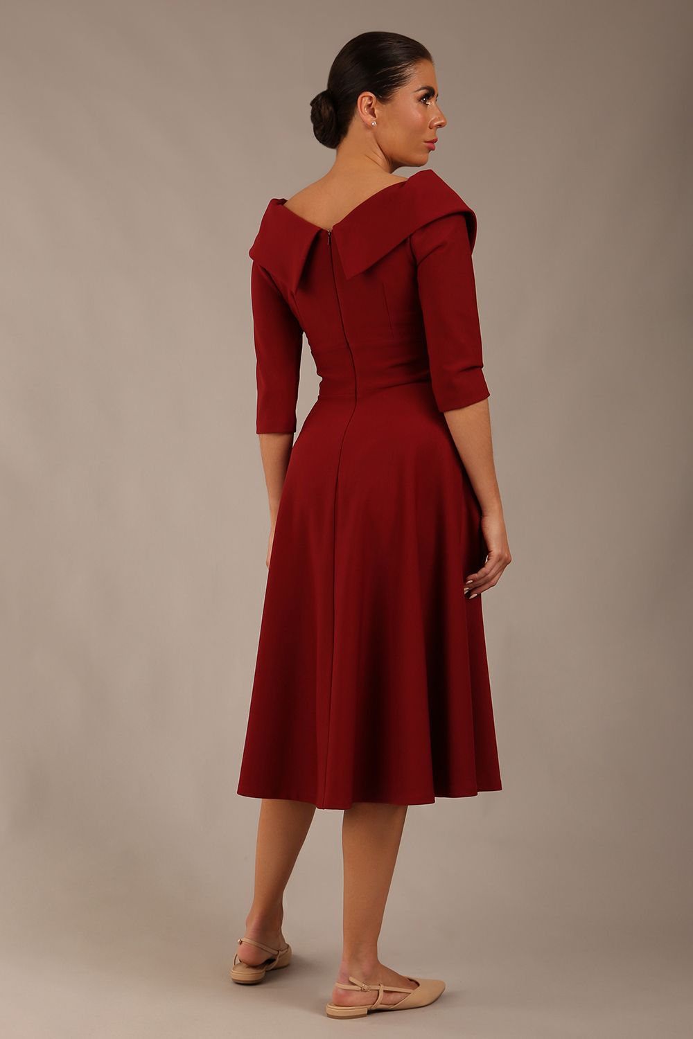 brunette model is wearing a diva catwalk Fabienne sleeved A-line Dress with pockets v neckline knee length wide waistband fold over v neckline in burgundy colour front image (Rio Red)