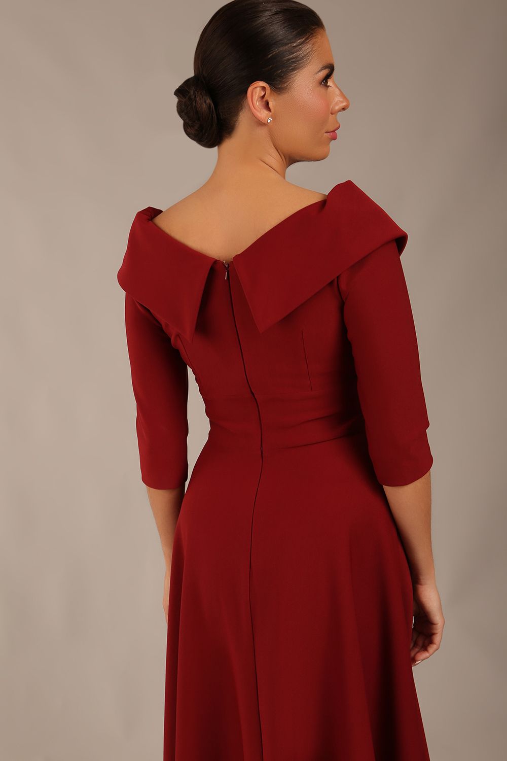 brunette model is wearing a diva catwalk Fabienne sleeved A-line Dress with pockets v neckline knee length wide waistband fold over v neckline in burgundy colour front image (Rio Red)