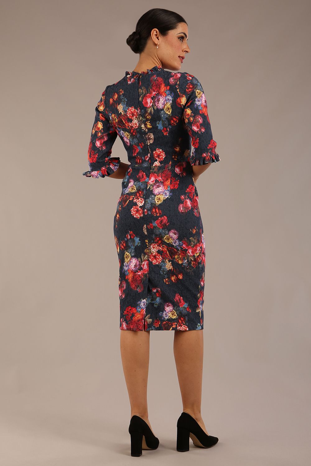 Model wearing the Portofino frill neck floral jacquard dress against a plain background (Hidcote Floral)