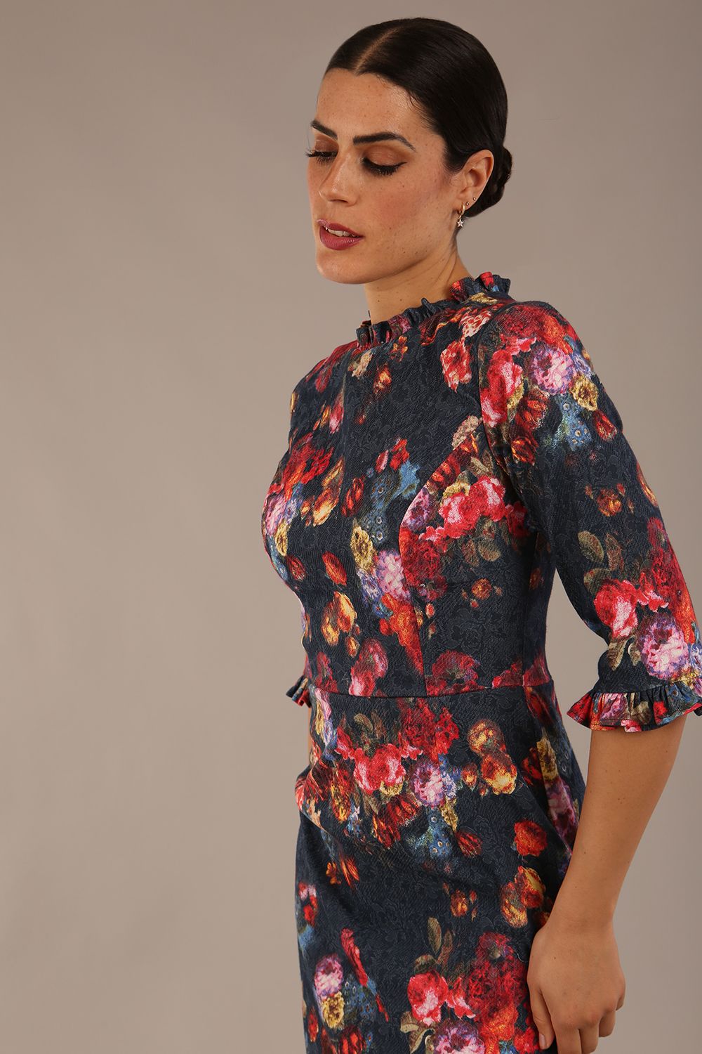Model wearing the Portofino frill neck floral jacquard dress against a plain background (Hidcote Floral)