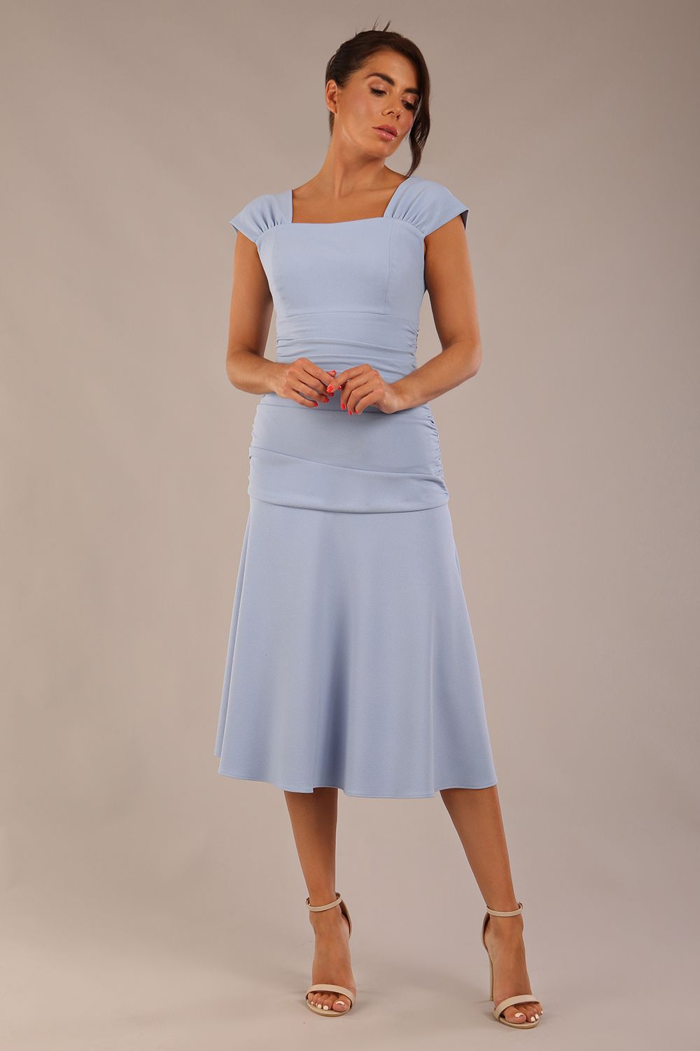brunette model is wearing a diva catwalk Sonning Cap Sleeve Square Neckline A-Line midi Dress and rushing side details in powder blue colour front