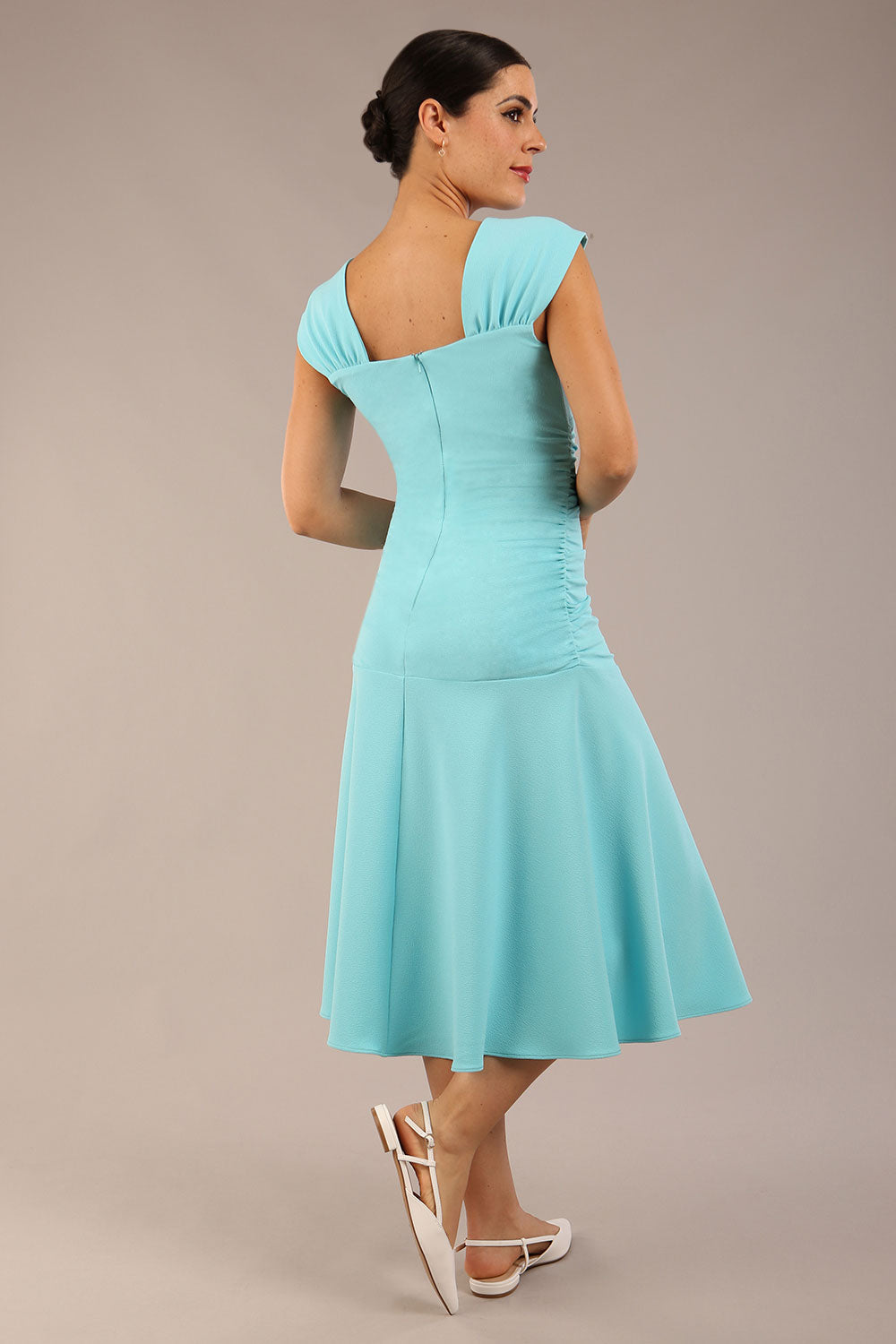 brunette model is wearing a diva catwalk Sonning Cap Sleeve Square Neckline A-Line midi Dress and rushing side details in turquoise colour front