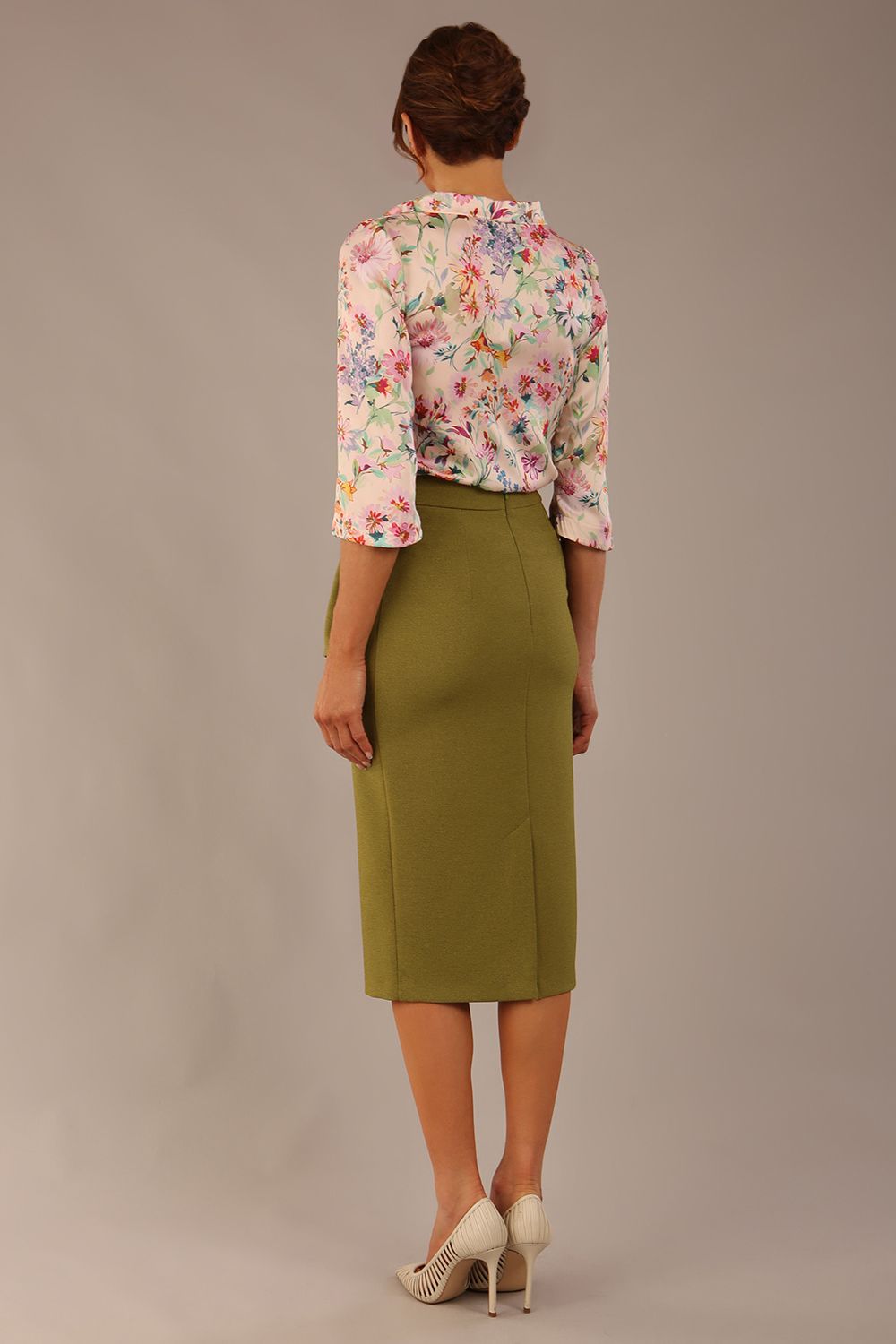 Model wearing the Rockwell 3/4 sleeve satin top in Lush Garden print, styled with an olive green pencil skirt (Lush Garden Satin Print)
