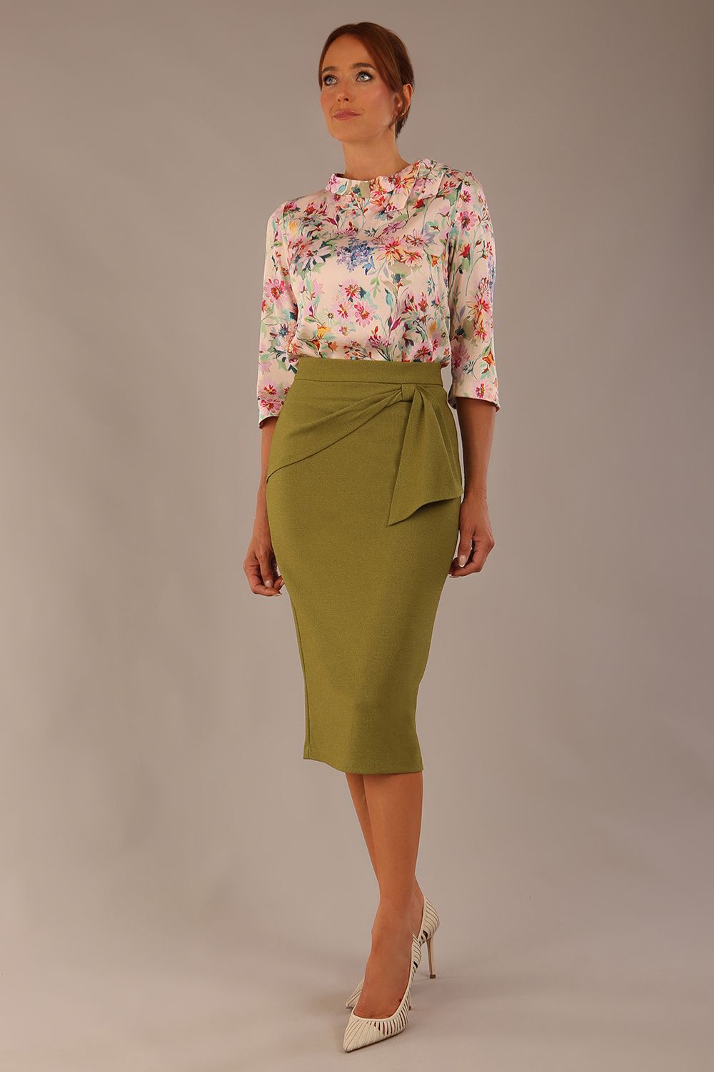 Model wearing the Rockwell 3/4 sleeve satin top in Lush Garden print, styled with an olive green pencil skirt (Lush Garden Satin Print)