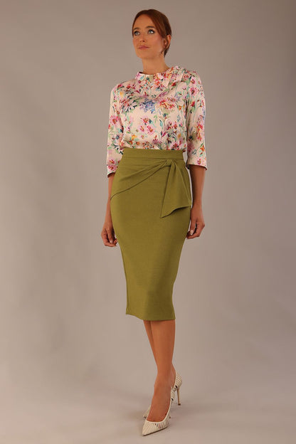 Model wearing the Rockwell 3/4 sleeve satin top in Lush Garden print, styled with an olive green pencil skirt (Lush Garden Satin Print)