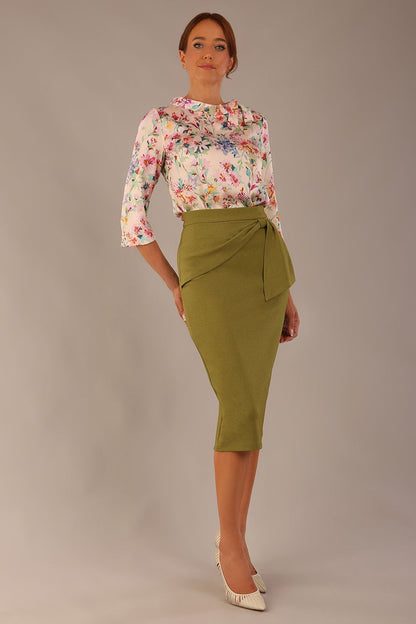 Model wearing the Rockwell 3/4 sleeve satin top in Lush Garden print, styled with an olive green pencil skirt (Lush Garden Satin Print)