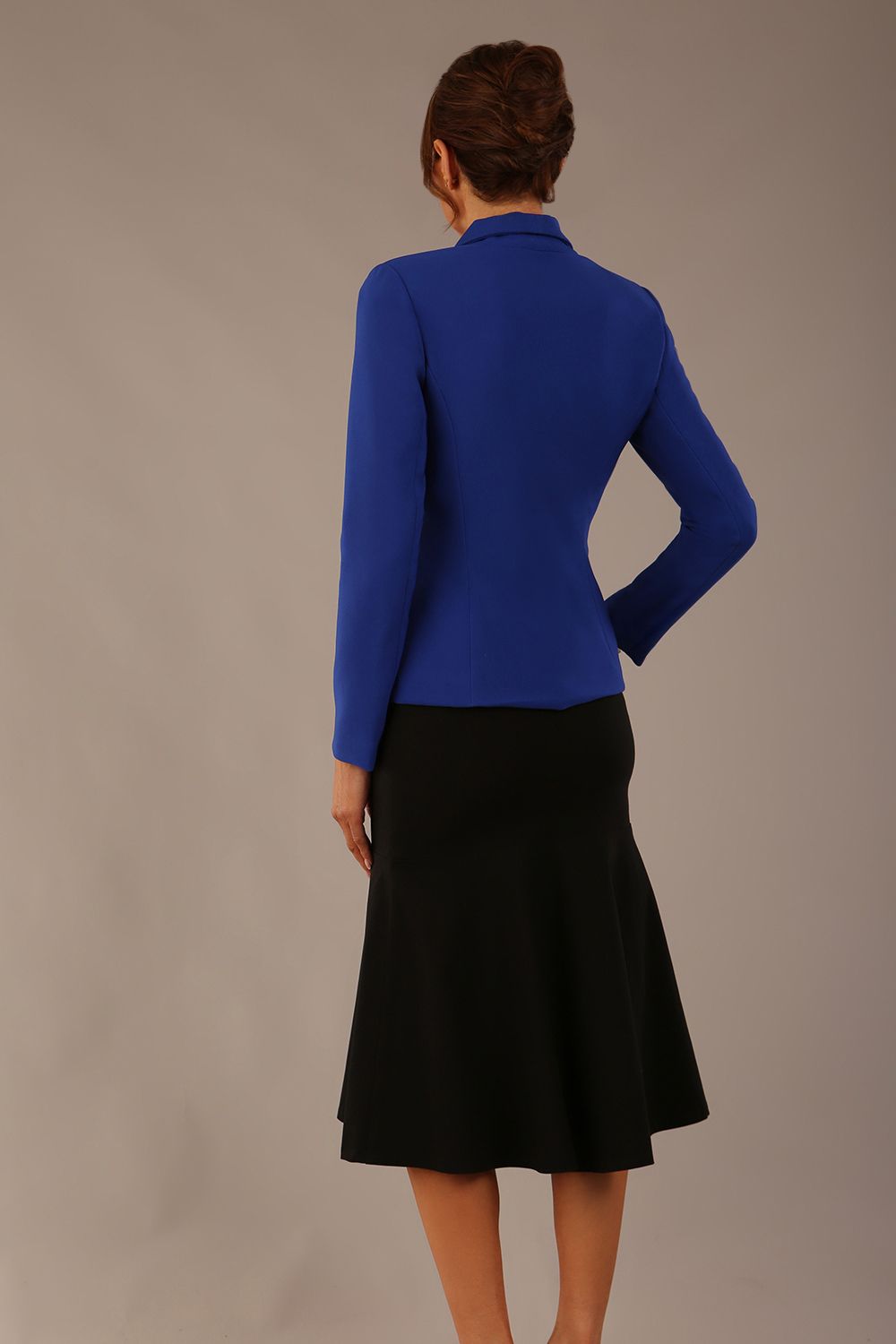 Model wearing the Melberry tailored jacket in royal blue, showing the sculpted waist and statement lapel detail (Royal Blue)