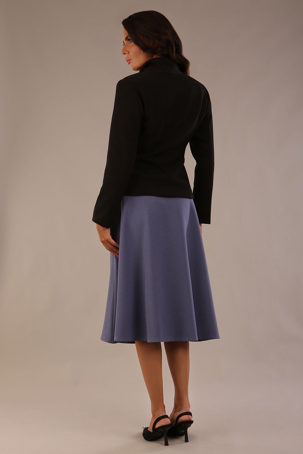 Model wearing the Harlow A-line midi skirt in blue mineral, with the side-tie fastened in a bow (Blue Mineral)