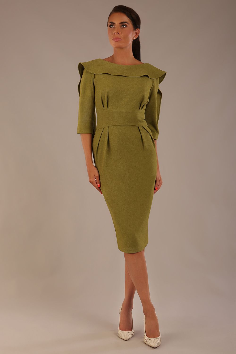 Model wearing the Rio statement collar pencil dress in oasis green, showcasing its architectural silhouette (Oasis Green)